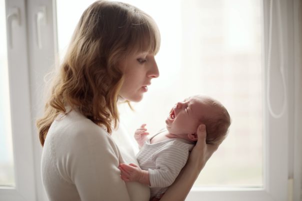 A mother comforting a baby with colic